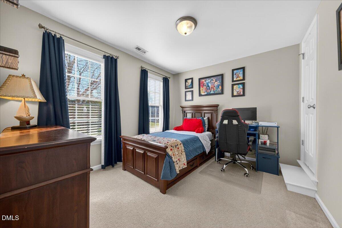 517 Lemon Pepper Place Wendell, NC 27591 - Photo 17 of 19 a living room with a bed furniture and a window