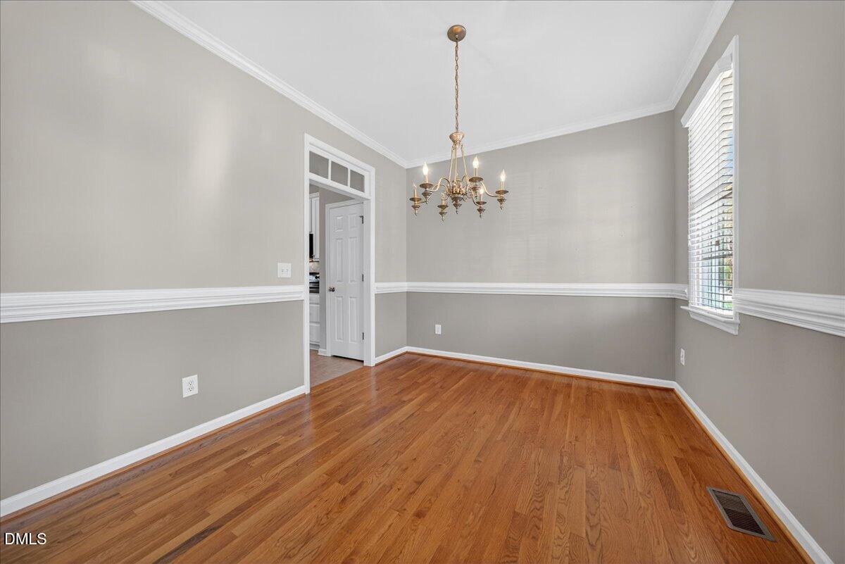 517 Lemon Pepper Place Wendell, NC 27591 - Photo 4 of 19 a view of a room with wooden floor staircase and a kitchen