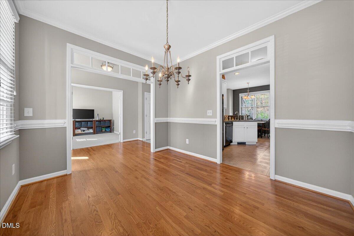 517 Lemon Pepper Place Wendell, NC 27591 - Photo 5 of 19 a view of a big room with wooden floor and a kitchen