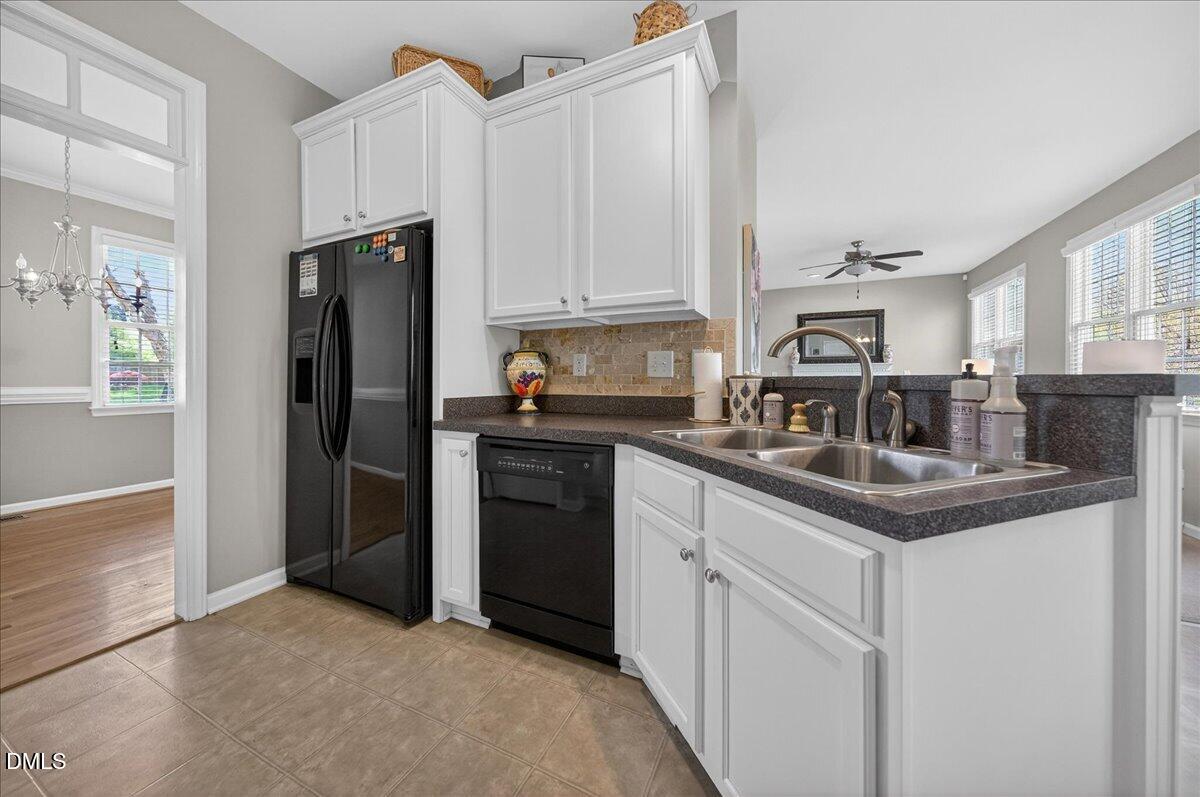 517 Lemon Pepper Place Wendell, NC 27591 - Photo 6 of 19 a kitchen with stainless steel appliances granite countertop a refrigerator a sink a stove and white cabinets
