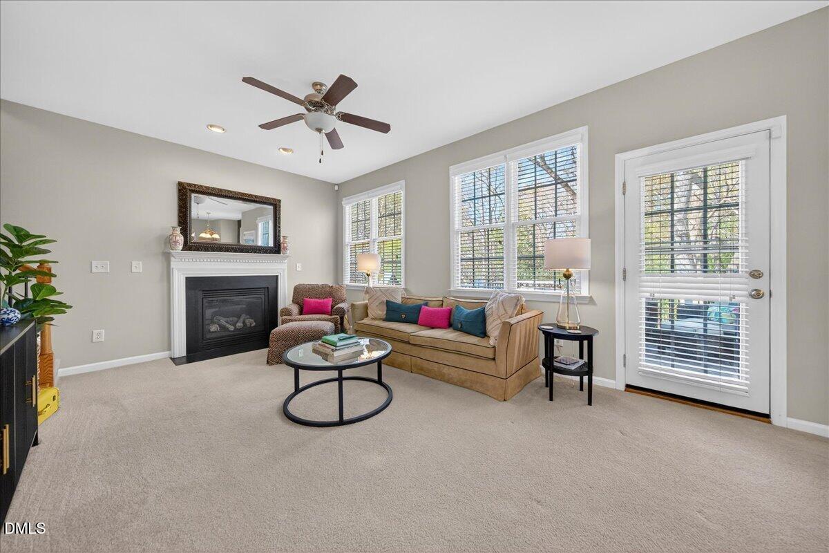 517 Lemon Pepper Place Wendell, NC 27591 - Photo 10 of 19 a living room with furniture a flat screen tv and a fireplace