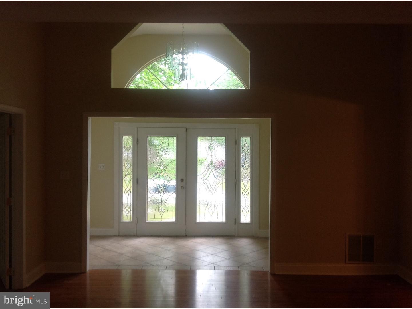 16 Oniontown Road Medford, NJ 08055 - Photo 2 of 25 a view of hallway with wooden floor and a floor to ceiling window