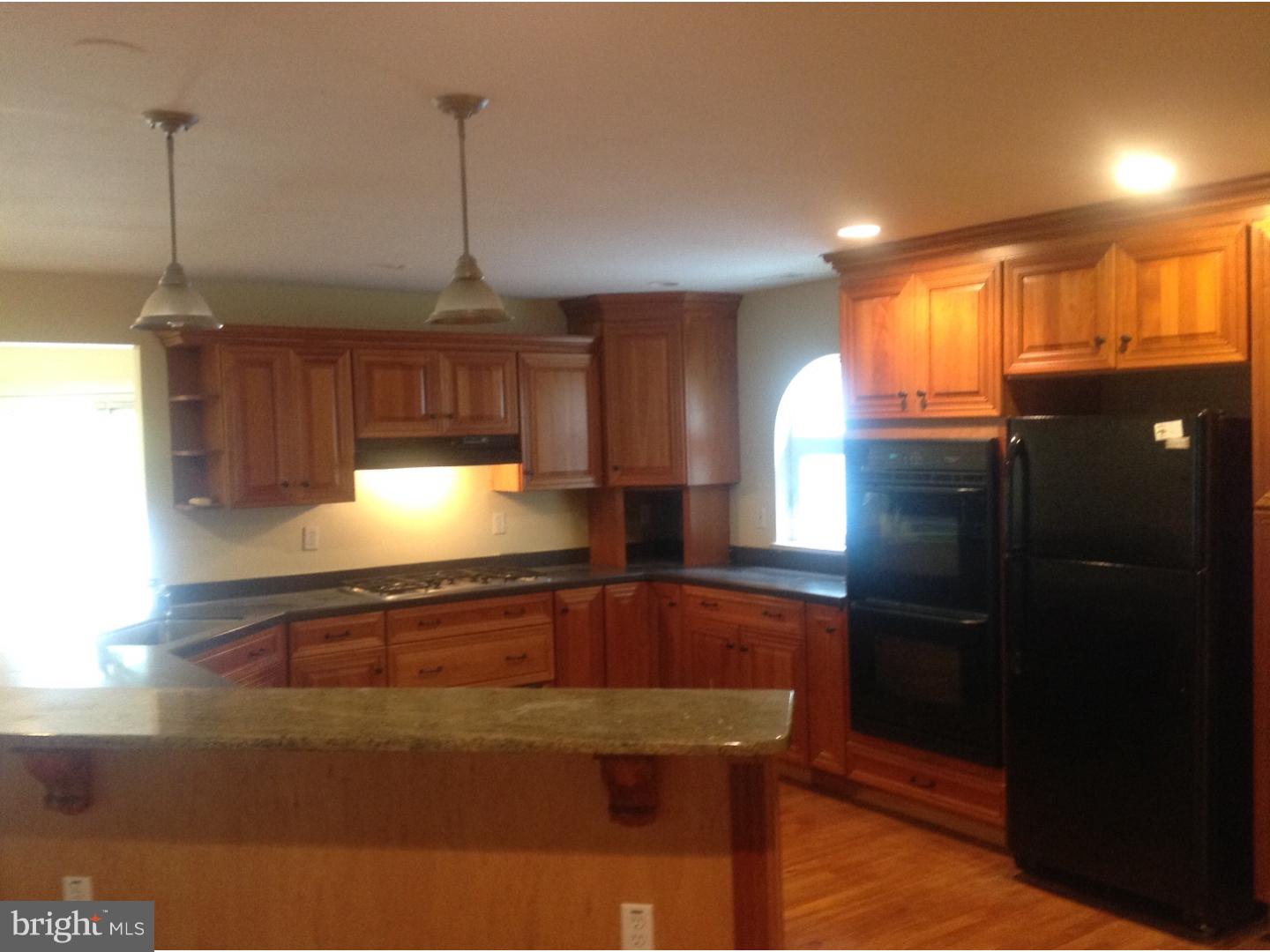 16 Oniontown Road Medford, NJ 08055 - Photo 6 of 25 a kitchen with stainless steel appliances granite countertop a sink a microwave cabinets and a dining table