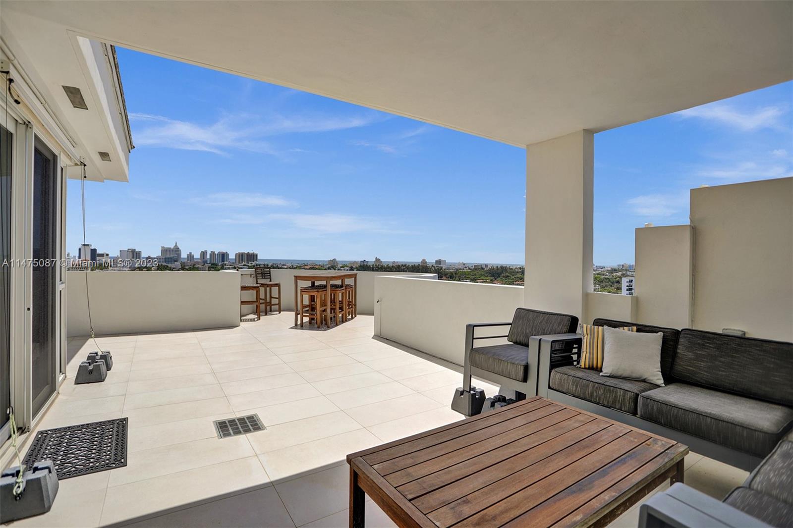 1621 Bay Road, Unit PH5 Miami Beach, FL 33139 - Photo 8 of 19 a bed sitting in a bedroom next to a larger window