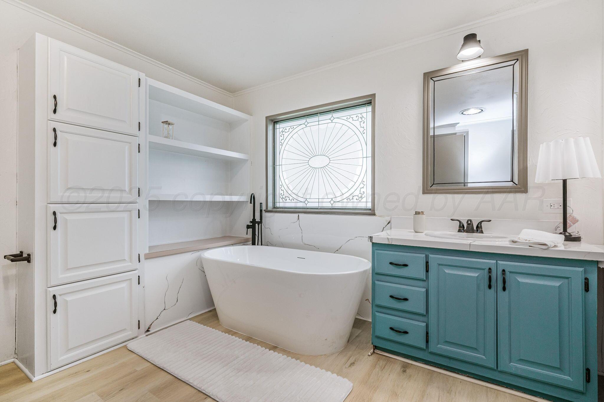 200 5th Avenue Canyon, TX 79015 - Photo 11 of 18 a spacious bathroom with double vanity sink a mirror and a bathtub