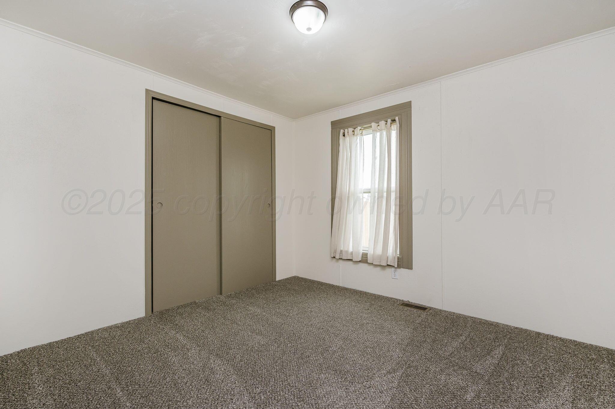 200 5th Avenue Canyon, TX 79015 - Photo 12 of 18 an empty room with windows and closet