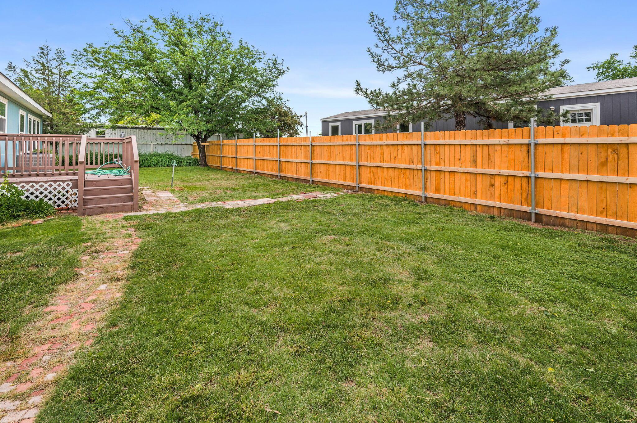 200 5th Avenue Canyon, TX 79015 - Photo 17 of 18 a view of a backyard with wooden fence and a bench