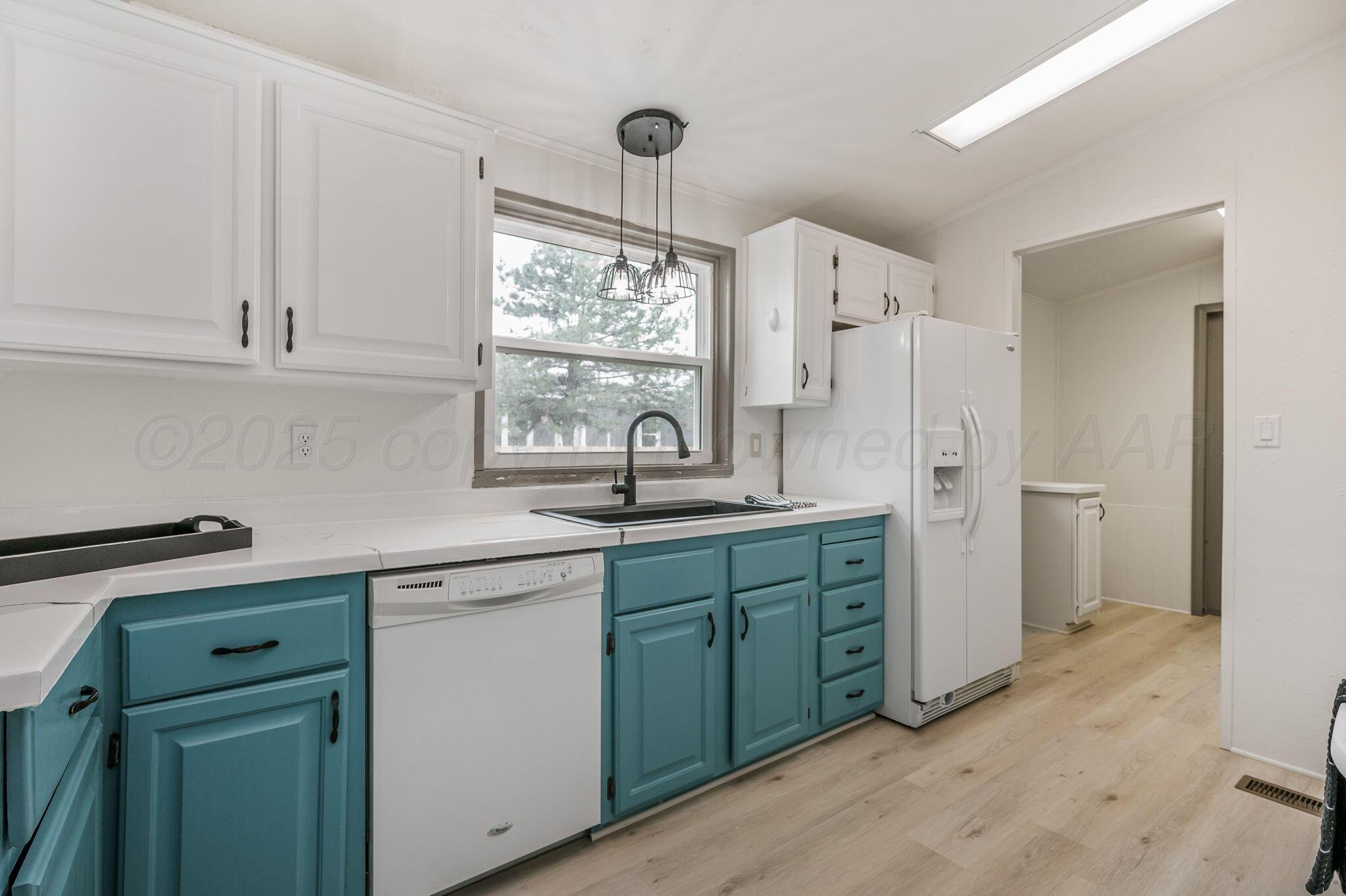 200 5th Avenue Canyon, TX 79015 - Photo 7 of 18 a kitchen with sink cabinets and window