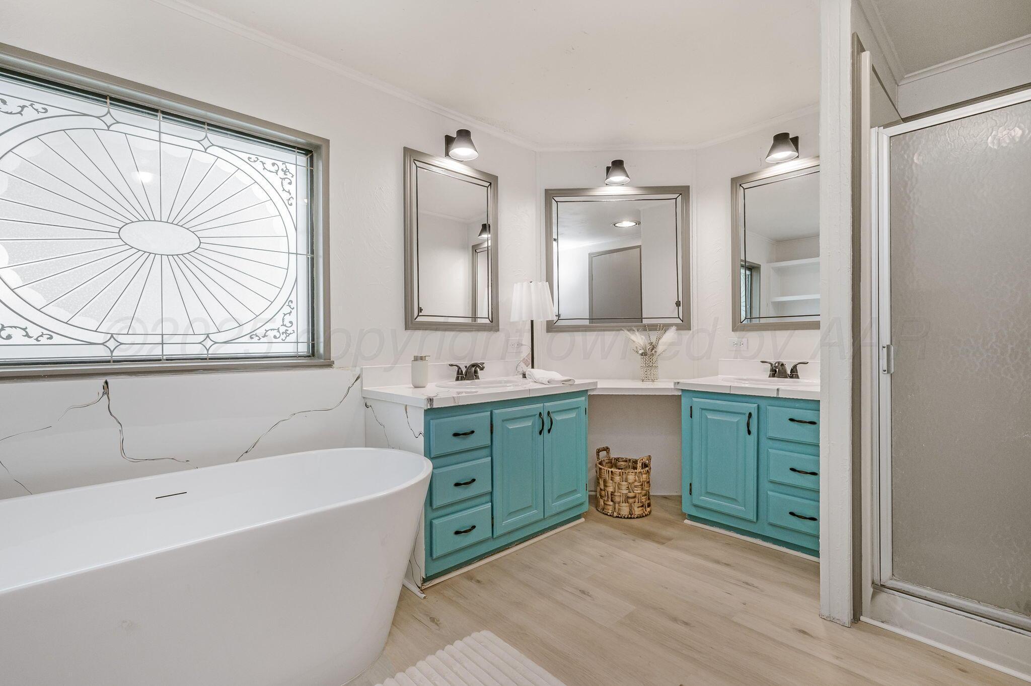 200 5th Avenue Canyon, TX 79015 - Photo 10 of 18 a spacious bathroom with a tub sink and mirror