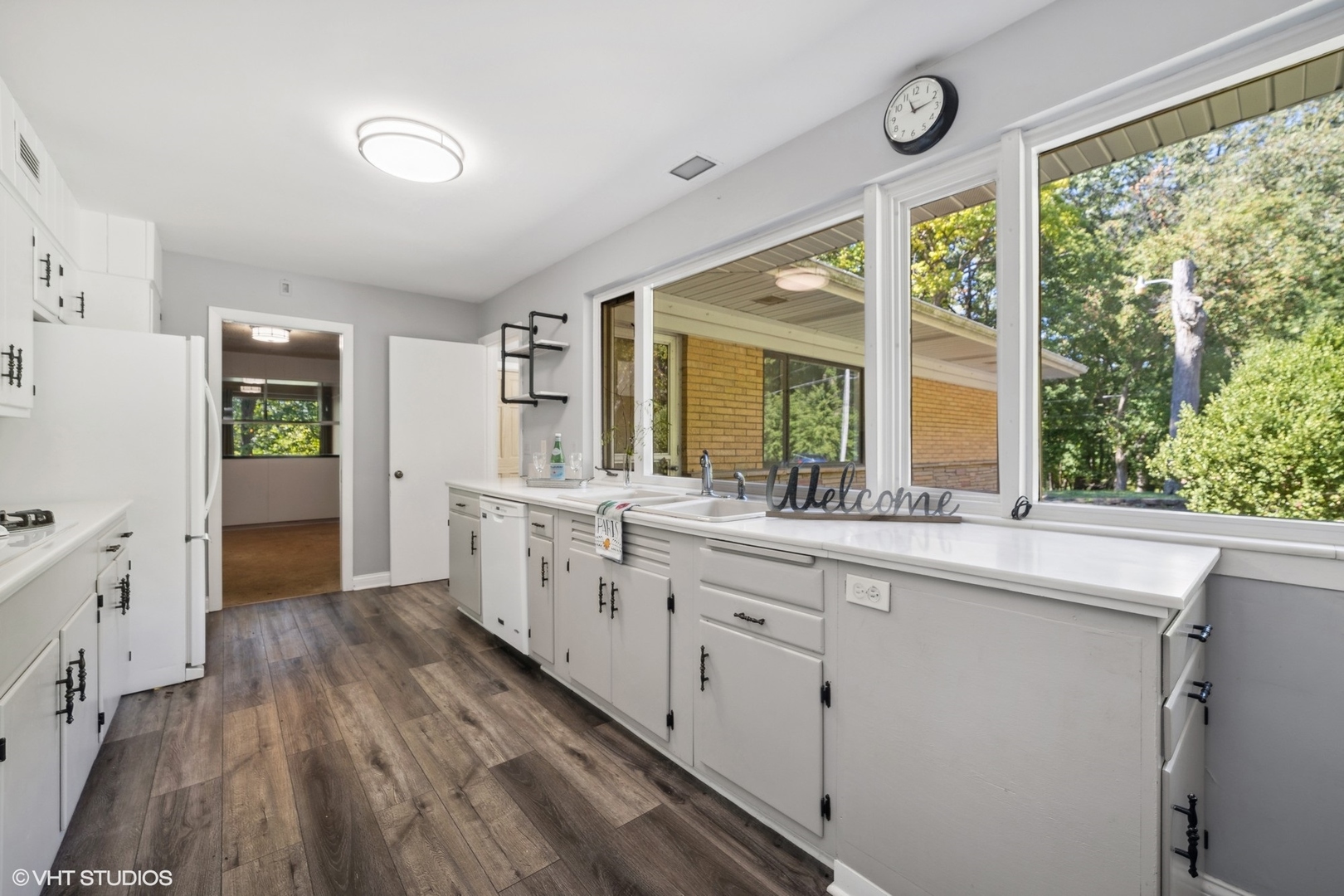 609 Ravine Road East Dundee, IL 60118 - Photo 7 of 15 a kitchen with white cabinets and wooden floors