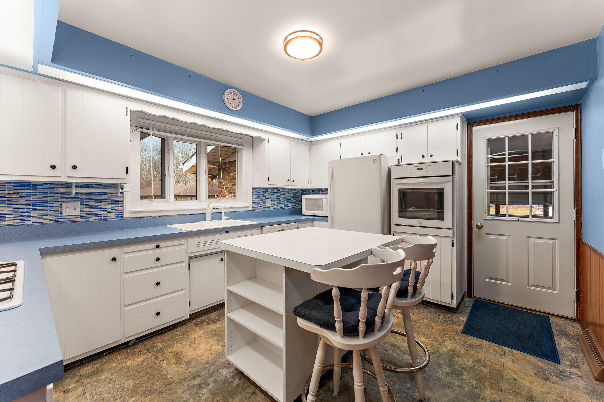1012 Meridian Road Chesterton, IN 46304 - Photo 11 of 39 a open kitchen with stainless steel appliances granite countertop a white cabinets and a stove top oven