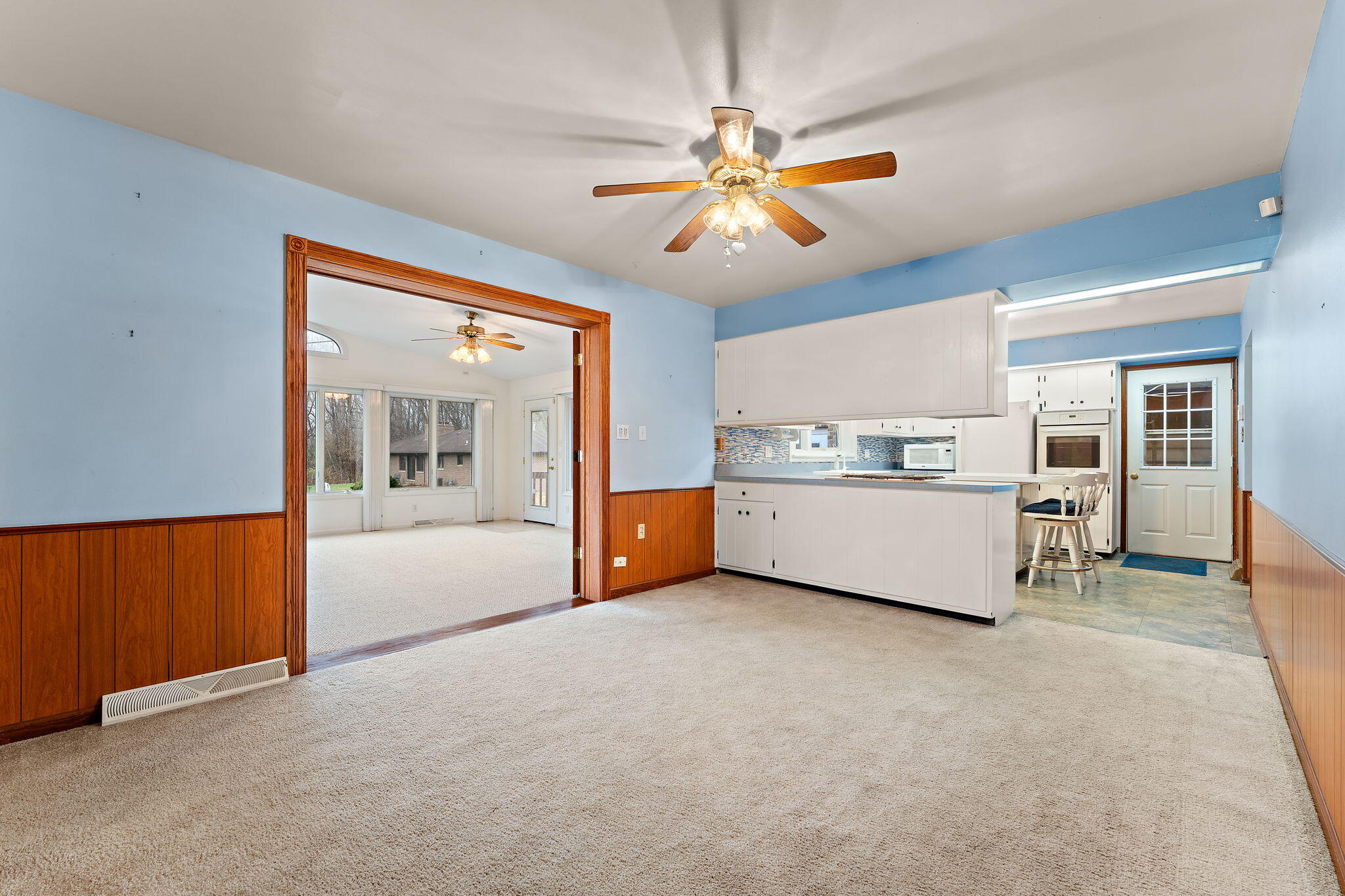 1012 Meridian Road Chesterton, IN 46304 - Photo 13 of 39 a view of a livingroom with a furniture ceiling fan and window