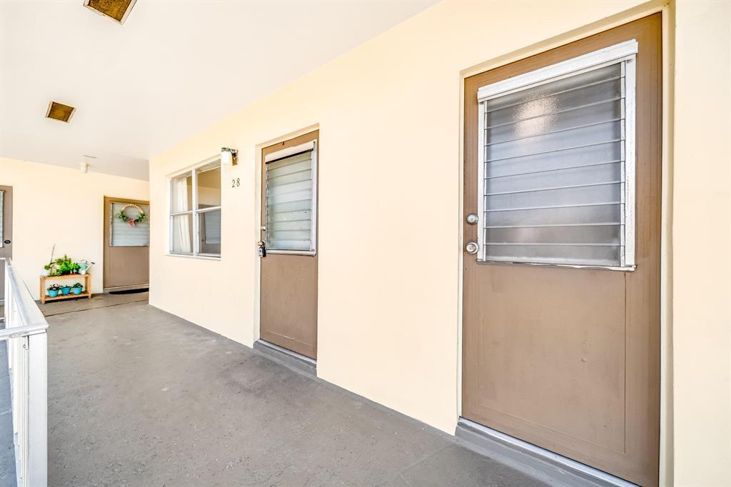 260 Northwest 19th Street, Unit 28 Boca Raton, FL 33432 - Photo 9 of 26 a view of a hallway with closet and wooden floor