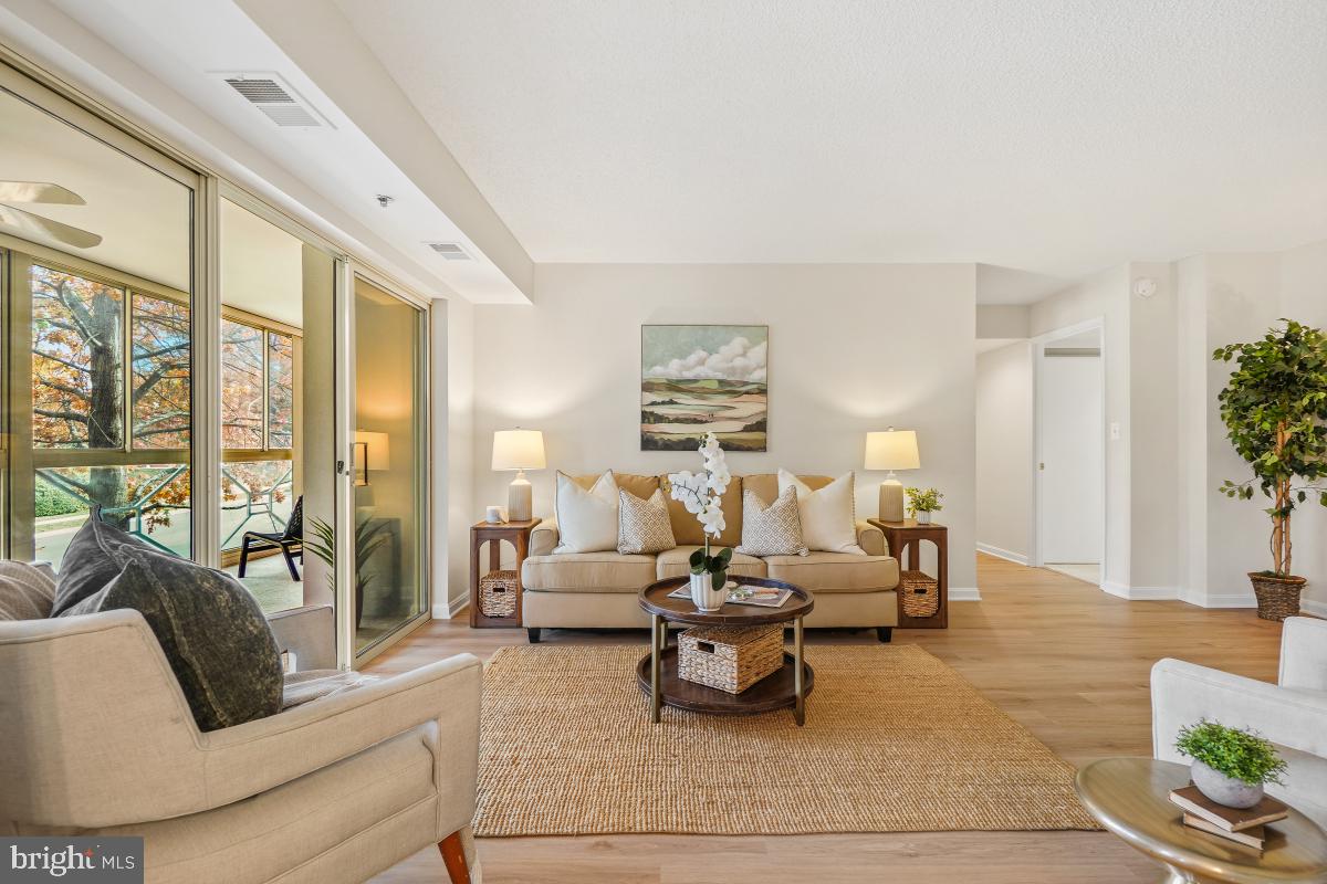 14801 Pennfield Circle, Unit 203 Silver Spring, MD 20906 - Photo 2 of 51 a living room with furniture and a large window