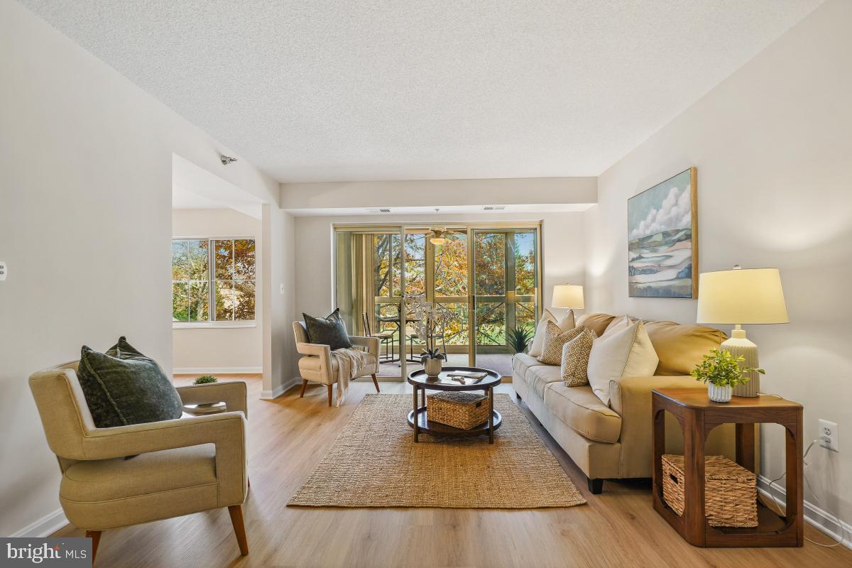 14801 Pennfield Circle, Unit 203 Silver Spring, MD 20906 - Photo 7 of 51 a living room with furniture and a large window
