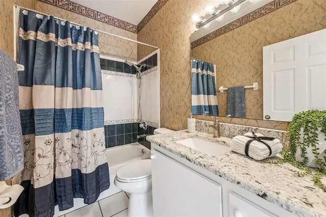 a living room with a large window and a rug