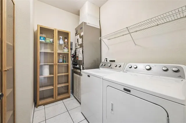 an aerial view of lake and residential houses with outdoor space