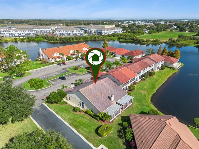 an aerial view of a building with garden space and street view