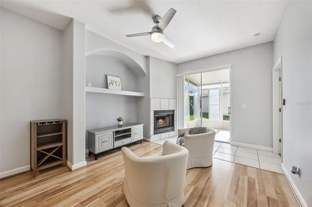 a view of a room with wooden floor and kitchen view