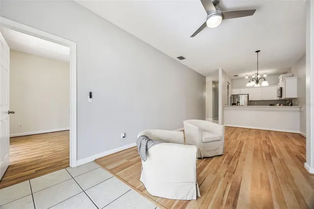 a view of a kitchen with kitchen island a sink and wooden floor