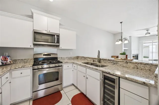 a kitchen with stainless steel appliances granite countertop a stove and a refrigerator