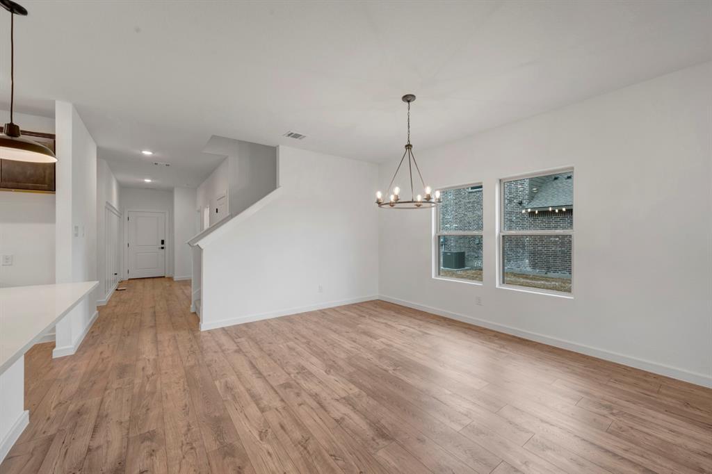 536 Brookside Drive Van Alstyne, TX 75495 - Photo 11 of 30 a view of empty room with wooden floor and stove