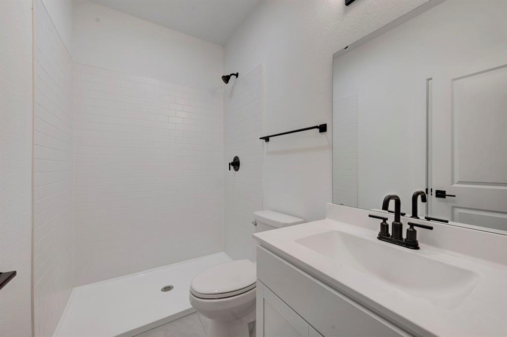 536 Brookside Drive Van Alstyne, TX 75495 - Photo 19 of 30 a bathroom with a sink a toilet and a mirror