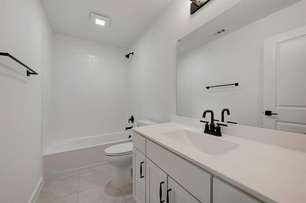 536 Brookside Drive Van Alstyne, TX 75495 - Photo 24 of 30 a bathroom with a sink a toilet and shower
