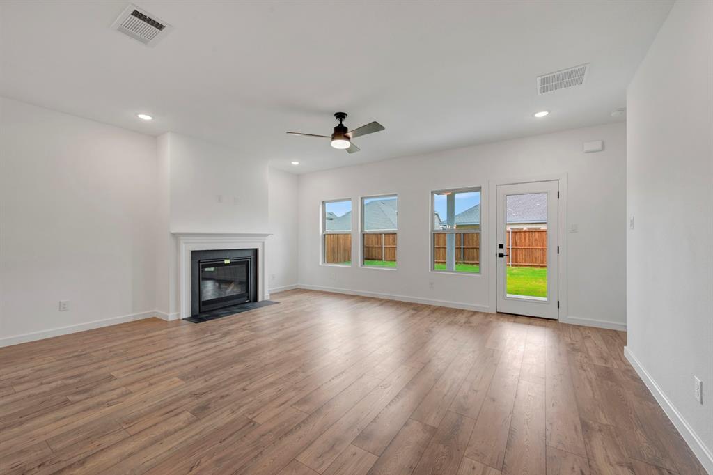 536 Brookside Drive Van Alstyne, TX 75495 - Photo 4 of 30 a view of an empty room with wooden floor and a window
