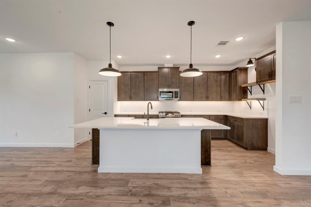 536 Brookside Drive Van Alstyne, TX 75495 - Photo 7 of 30 a kitchen with kitchen island a sink stainless steel appliances and cabinets