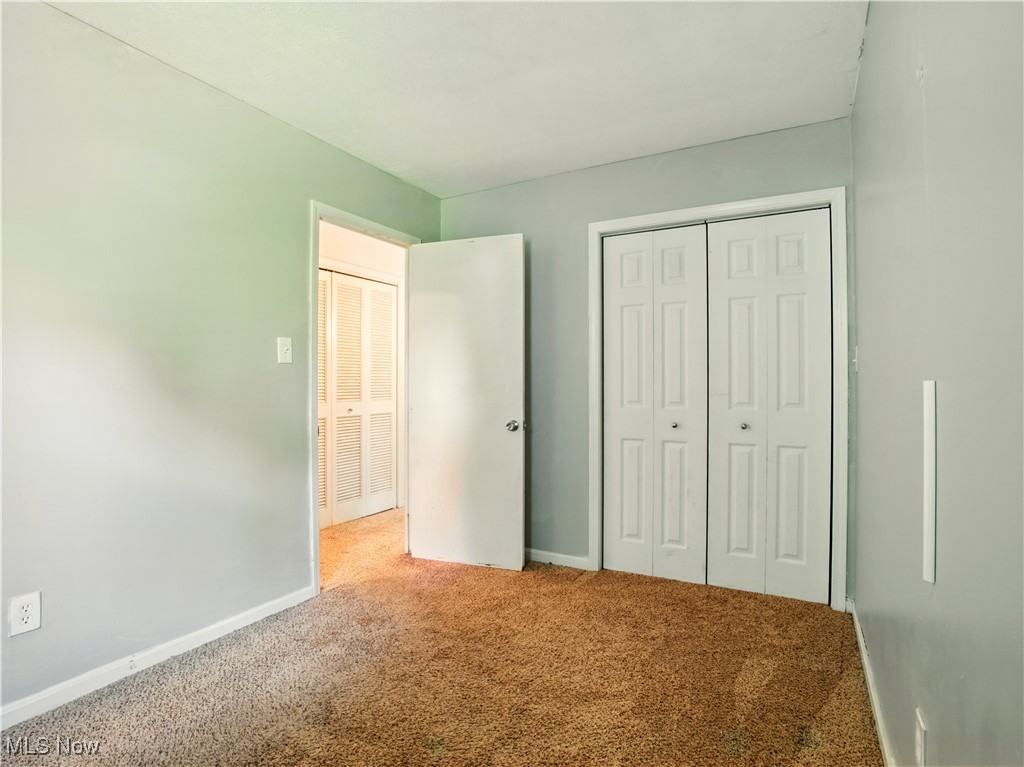 1942 Benjamin Road Madison, OH 44057 - Photo 15 of 29 Unfurnished bedroom with carpet floors, baseboards, and a closet