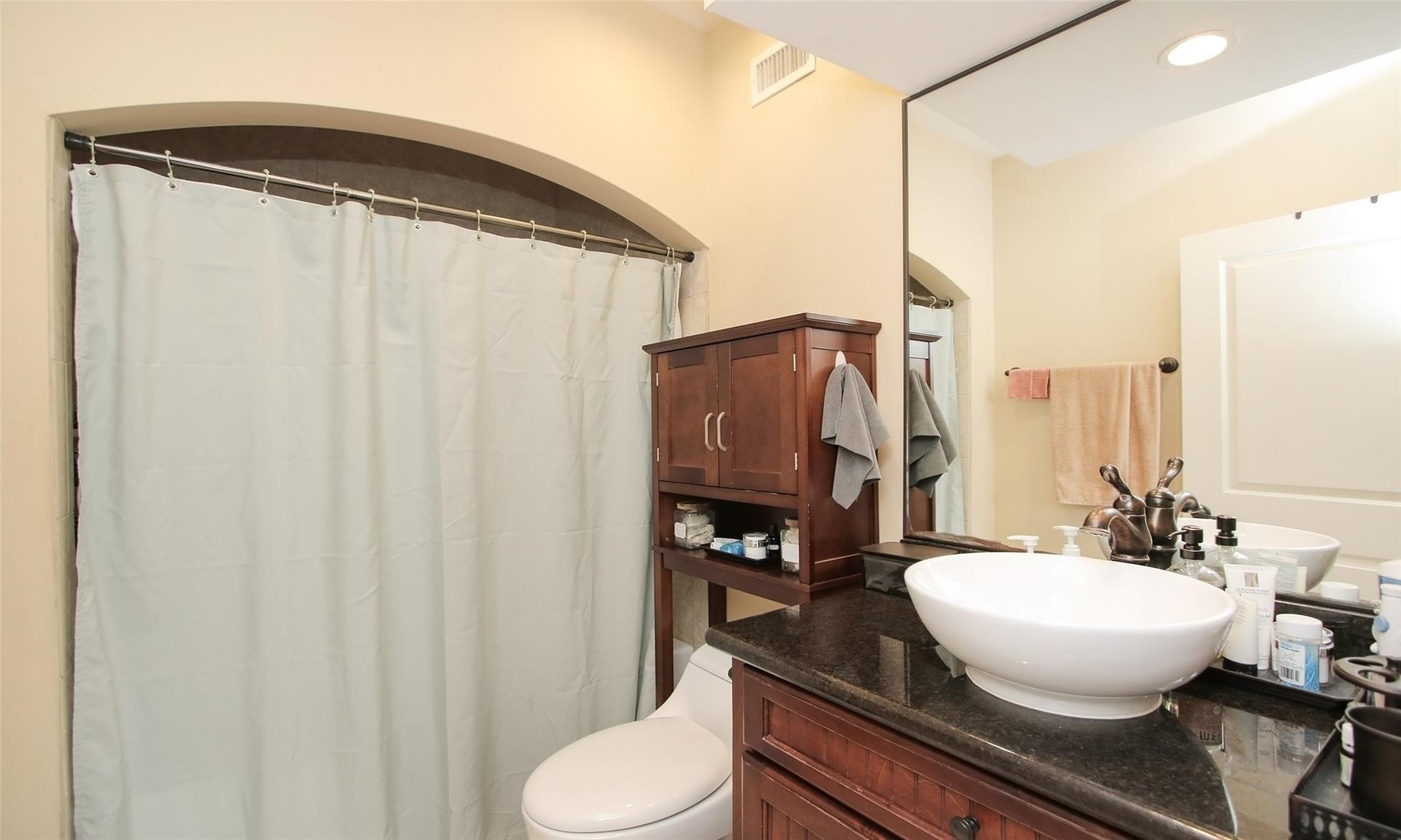 2203 Dorrington Street, Unit 208 Houston, TX 77030 - Photo 20 of 32 a bathroom with a granite countertop sink and a mirror