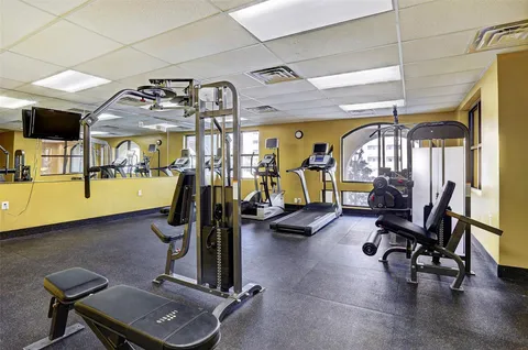 a building outdoor space with patio furniture and potted plants