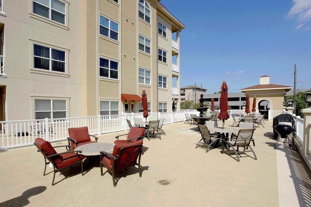 2203 Dorrington Street, Unit 208 Houston, TX 77030 - Photo 26 of 32 a building outdoor space with patio furniture and potted plants