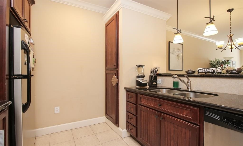 2203 Dorrington Street, Unit 208 Houston, TX 77030 - Photo 8 of 32 a kitchen with a sink and a refrigerator