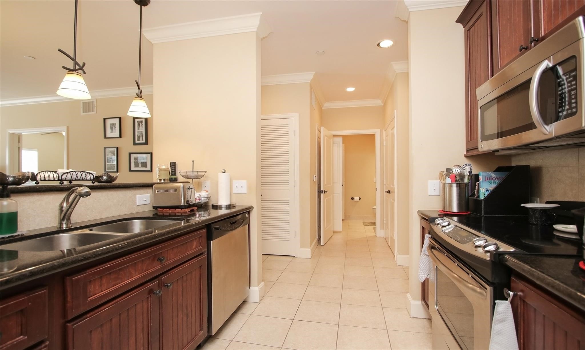 2203 Dorrington Street, Unit 208 Houston, TX 77030 - Photo 9 of 32 a kitchen with a sink and a stove