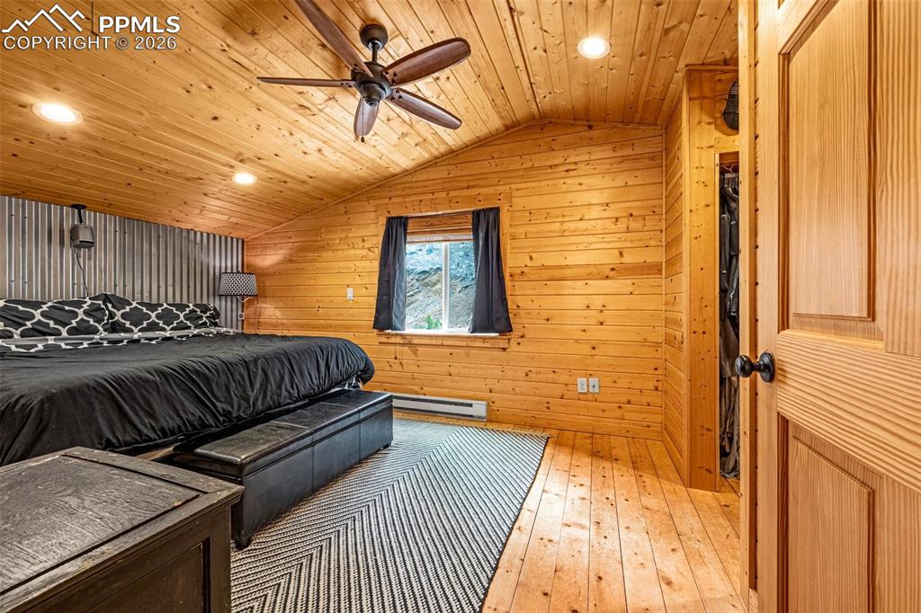 325 Willow Road Divide, CO 80814 - Photo 19 of 45 a bedroom with a bed and wooden floor