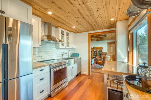 a kitchen with stainless steel appliances granite countertop a stove and refrigerator