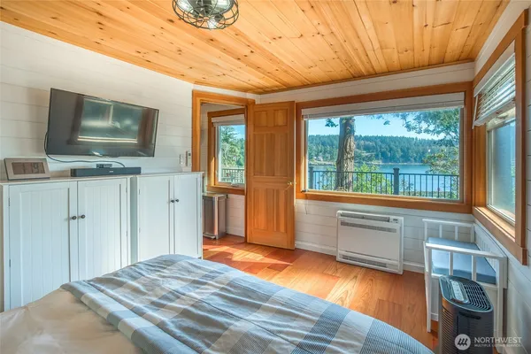 a bedroom with furniture and flat screen tv
