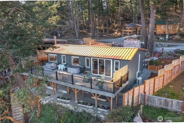 an aerial view of a house with swimming pool and sitting area