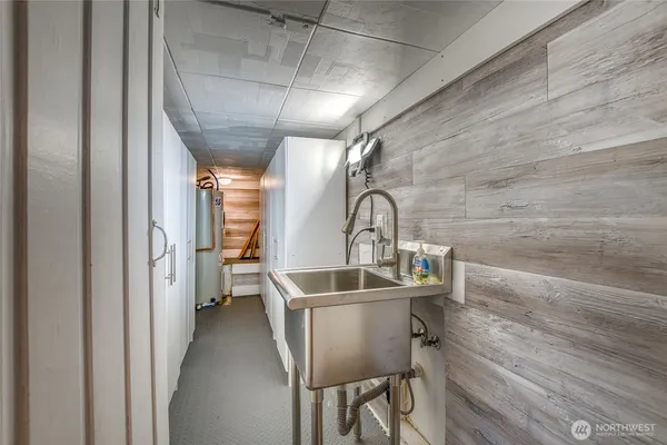 a room with a sink and wooden floor
