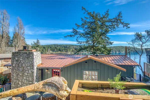 a view of backyard with swimming pool and seating space
