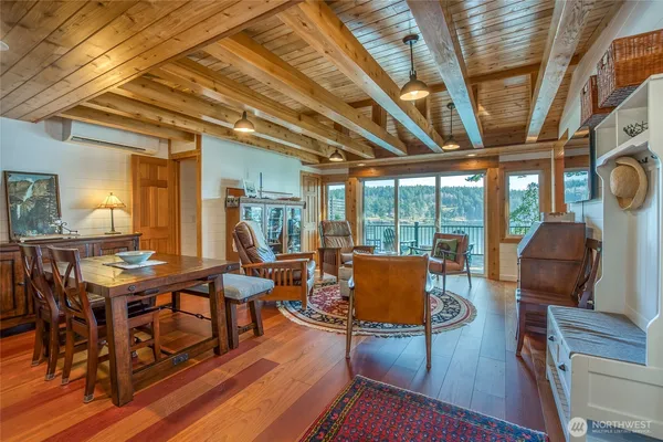 a living room with furniture wooden floor and large window