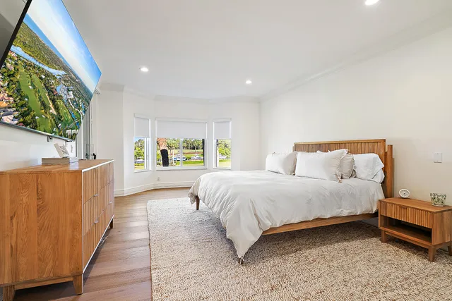 a spacious bedroom with a bed and window