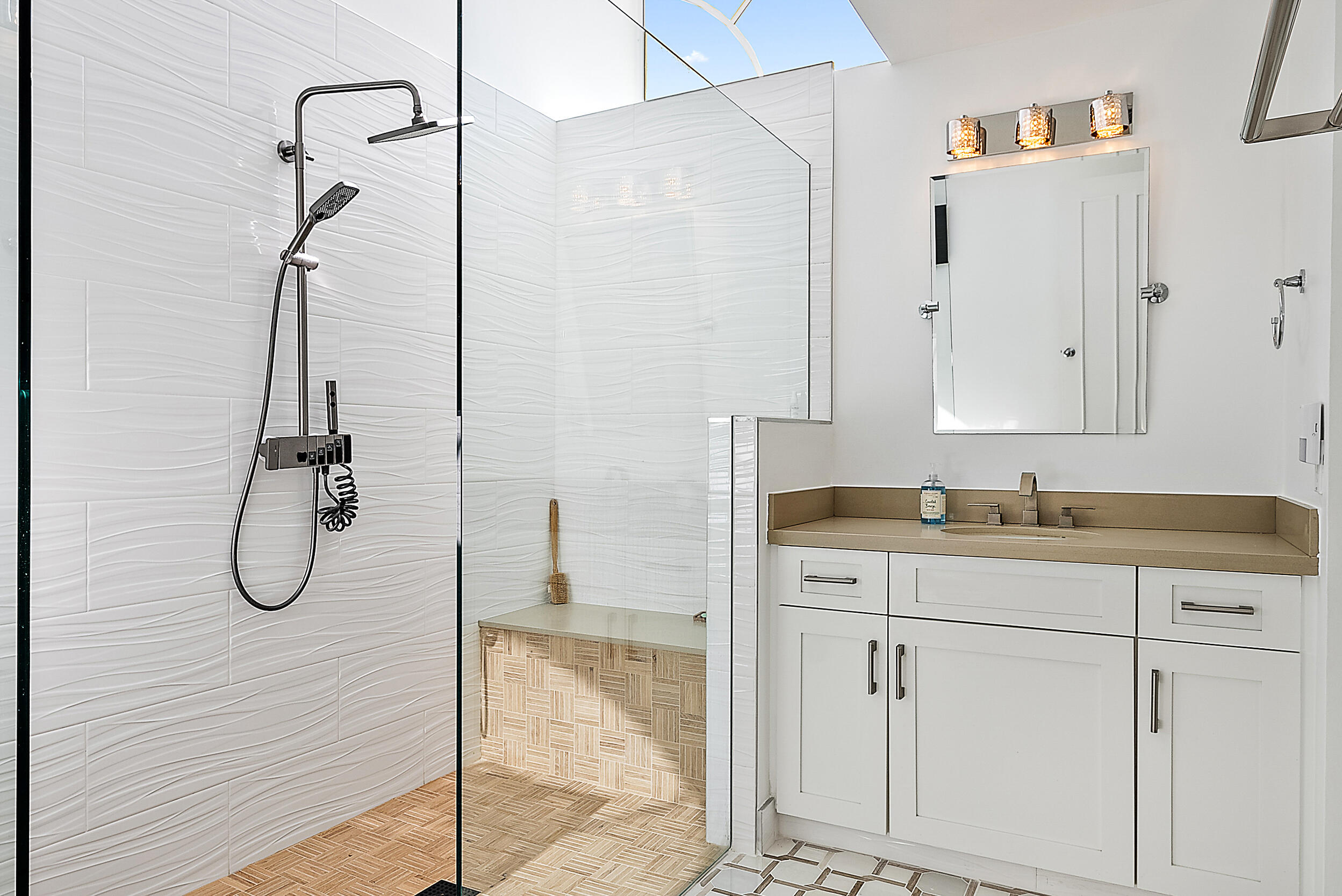 1602 Captains Way Jupiter, FL 33477 - Photo 13 of 36 a bathroom with a granite countertop sink a mirror and shower