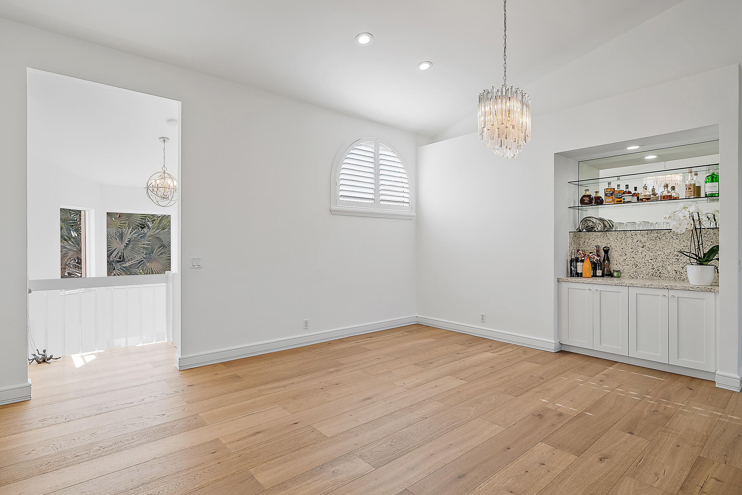 1602 Captains Way Jupiter, FL 33477 - Photo 8 of 36 an empty room with wooden floor and window