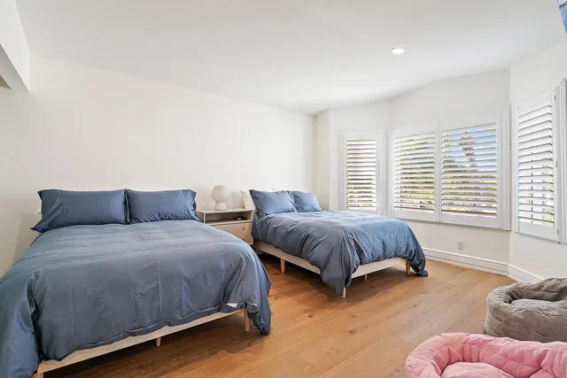 a spacious bedroom with two beds and a couch