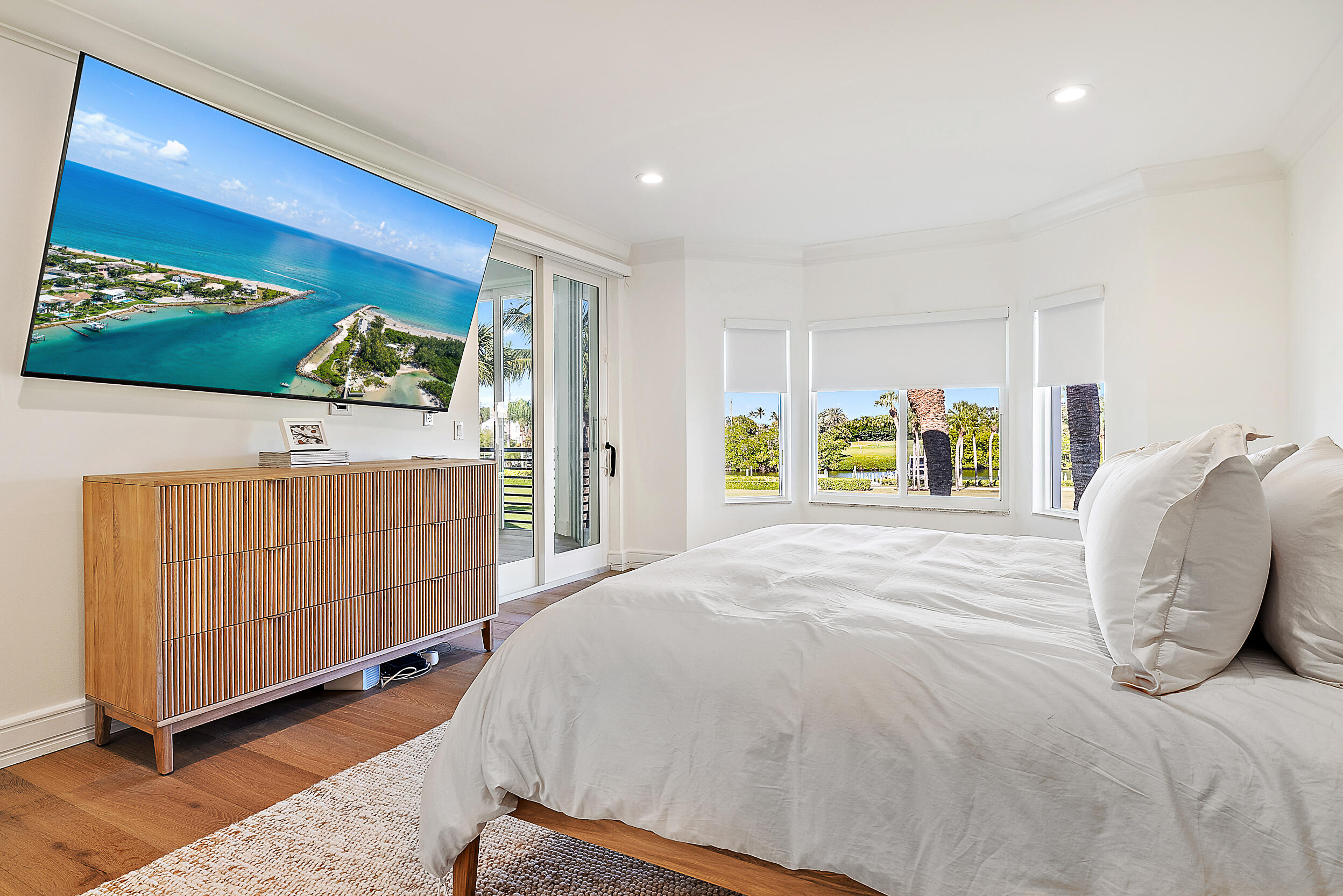 1602 Captains Way Jupiter, FL 33477 - Photo 10 of 36 a bedroom with a bed and a window