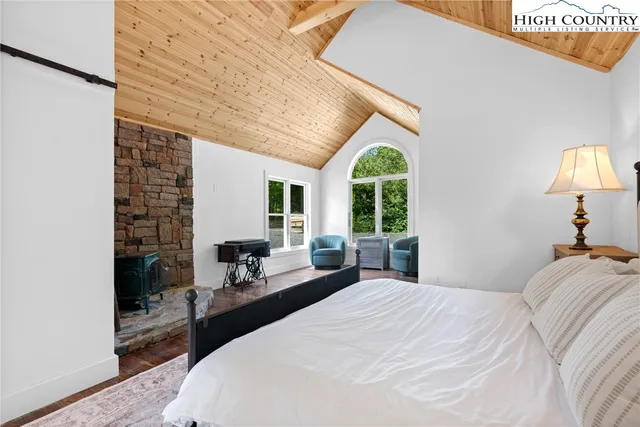 a bedroom with a bed and a large window