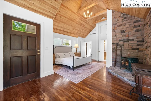 a spacious bedroom with a bed and a couch